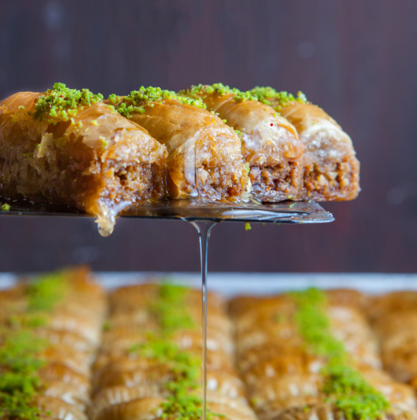A festive Middle Eastern dessert of stuffed pancakes, fried or baked, and soaked in fragrant syrup.